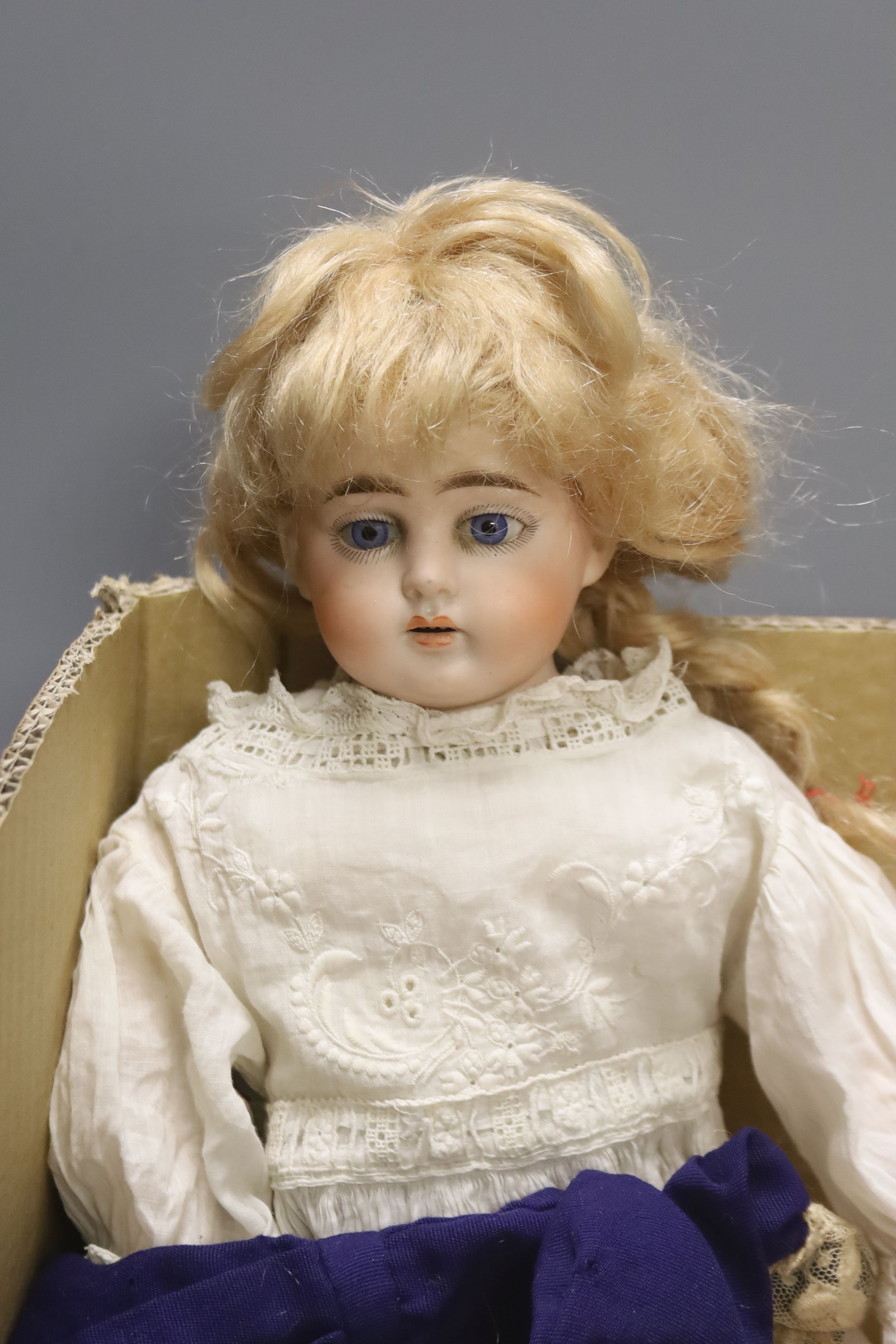 An Armand Marseille doll, an Ernst Heubach doll and a quantity of dolls' clothing, etc.